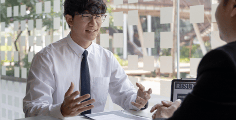 a man in a white shirt and tie talking to a person