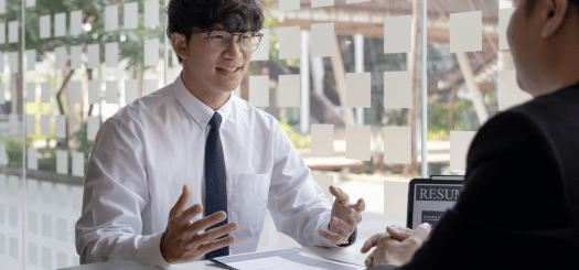 a man in a white shirt and tie talking to a person